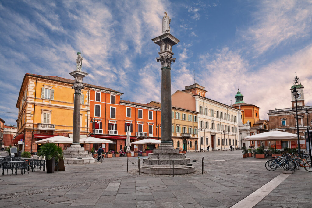 Ravenna, Emilia-Romagna, Italy: the main square Piazza del Popolo with the ancient columns with the statues of Saint Apollinare and Saint Vitale (Photo Credit: iStock)