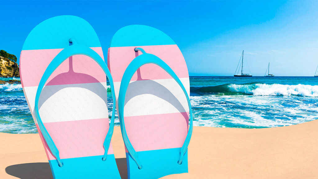 Transgender flag flip flops on a beach (Photo Credit: Shutterstock)