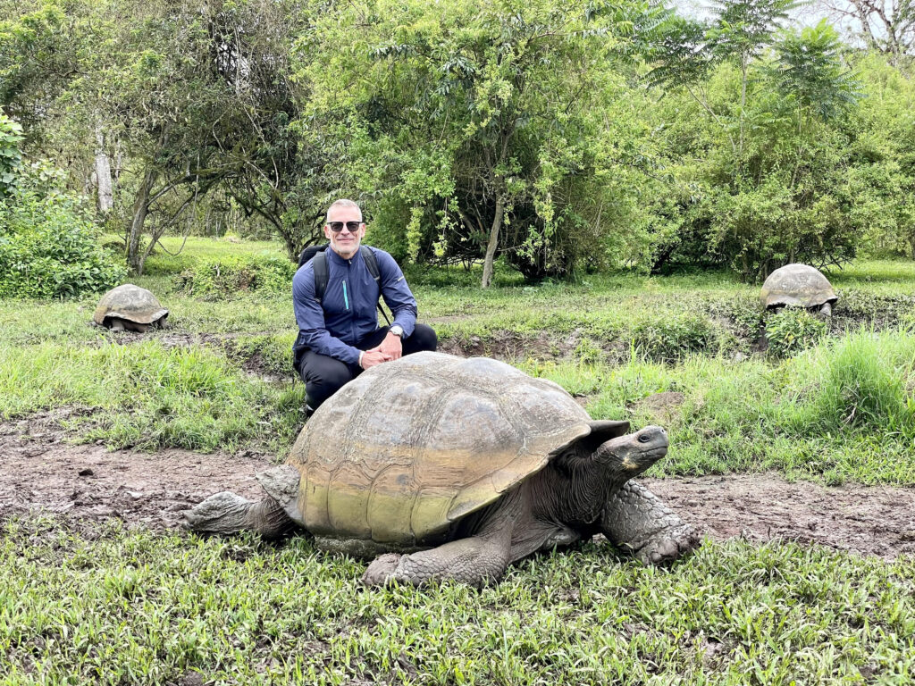 Carlos Melia with a giant tortoise on Santa Cruz Island, Galapagos, Ecuador (Photo Credit: Carlos Melia)