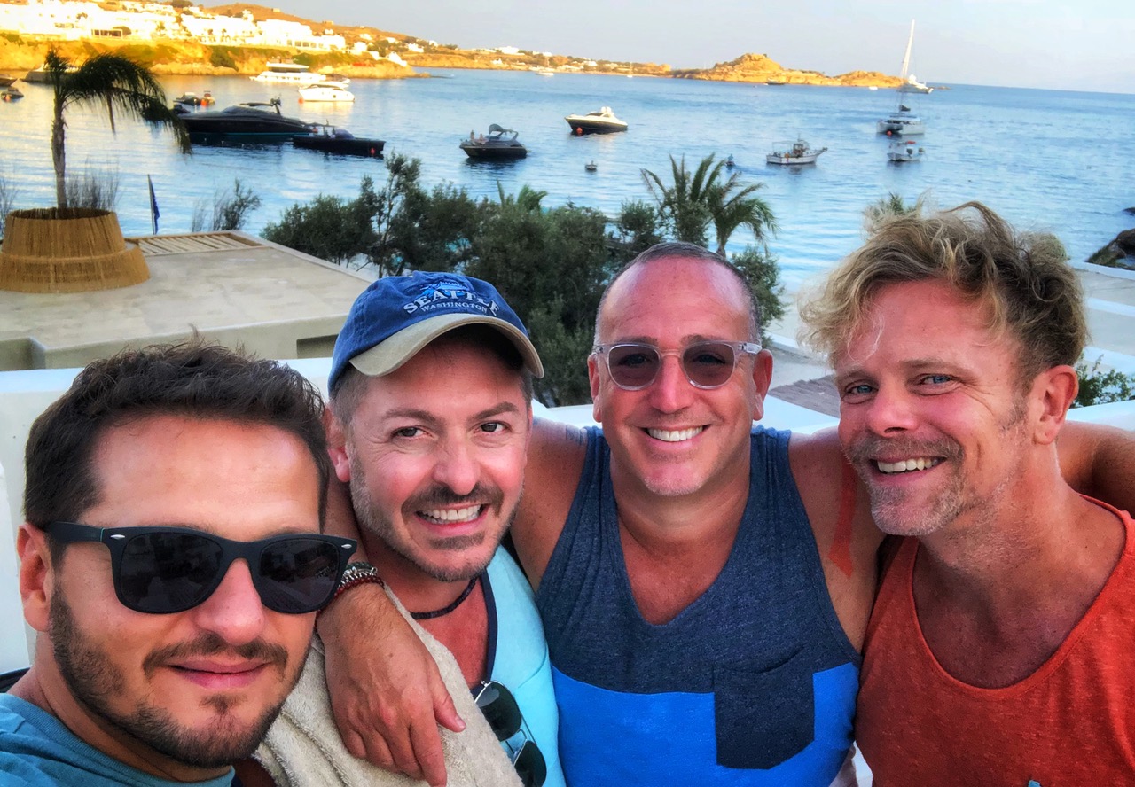 Keith and his husband Stefano Lorenzo (in the center) with friends in Mykonos, Greece (Photo Credit: Keith Wein)