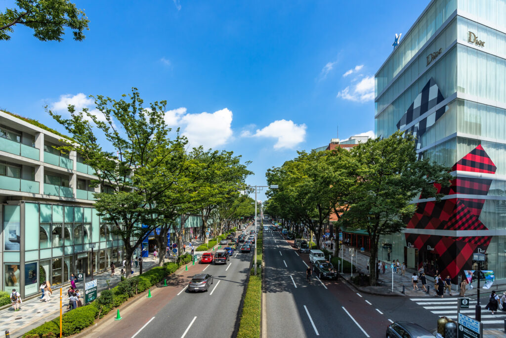 View of Omotesando street with many fashion luxury shops lined along the street in Tokyo, Japan. (Photo Credit: Francesco Bonino / Shutterstock)