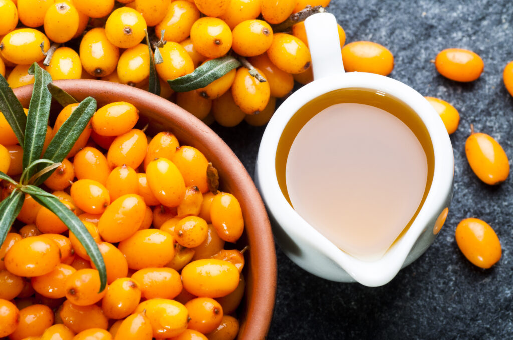 Sea buckthorn oil and berries (Photo Credit: nanka / Shutterstock)