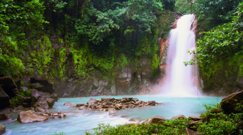 Get a Queer Digital Nomad Visa and you can visit places like Celeste Waterfalls in Costa Rica. (Photo Credit: OGphoto / iStock)