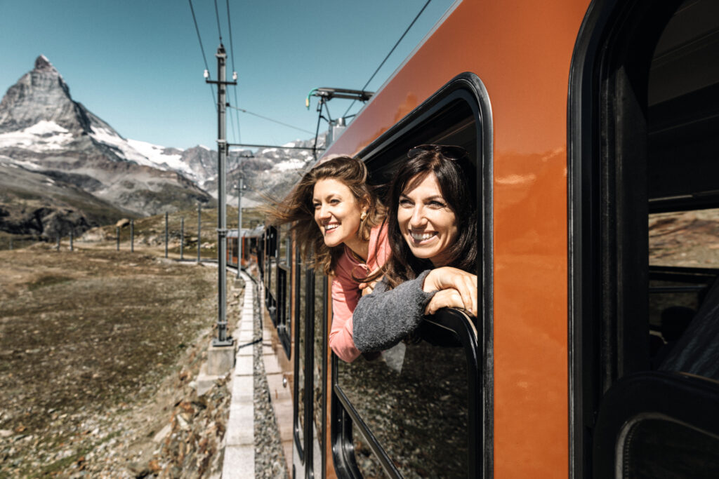 Couple on a Gornergrat Railway train in Switzerland (Photo Credit: Pink Alpine)