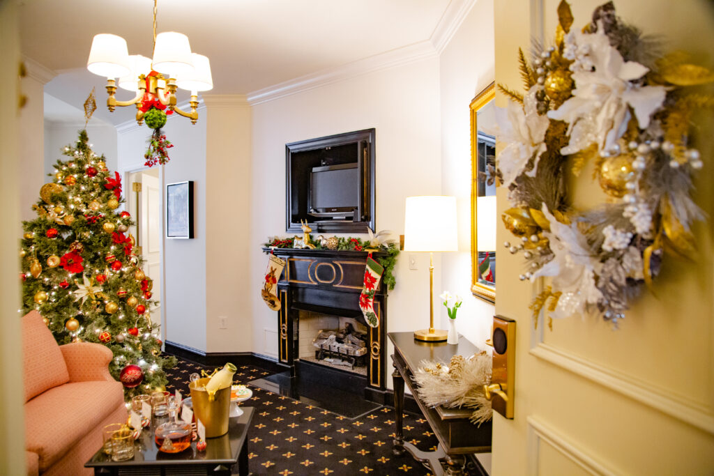 The fireplace and tree found in the Sleigh Bell Suite at the French Quarter Inn (Photo Credit: Kim Graham / French Quarter Inn)